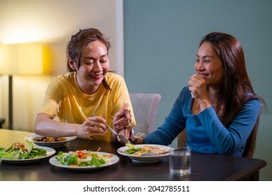Two Asian Woman Friends Having Dinner Eating Pasta And Salad With Talking Together At Home. Attractive Female Girlfriends Relax And Enjoy Indoor Lifestyle Activity And Holiday Celebration Together