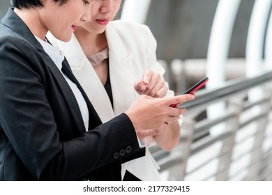 Two Asian Woman Talking Business Partners Using Digital Tablet Smartphone Meeting Outside Office At Street City. Teamwork Partnership Women Talking Discuss At Outdoor Office Partnership Team Advice.