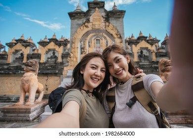Two Asian Woman Traveler Smile Take A Photo Selfie Together With Pagoda Of Buddhist Temple In Background. Travel Pagoda Of Buddhist In Asia.