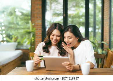 Two Asian Woman Using Laptop For Shopping Online With Credit Card Payment