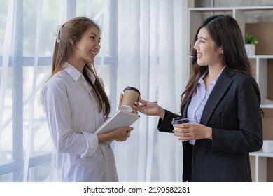 Two Asian women with laptop and financial graphs calculating accounting and taxes at the office. business idea - Shutterstock ID 2190582281