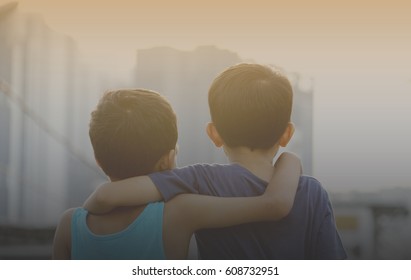 Two Asian Young Brothers Hugging Each Others Over The Sunset. Brotherhood Friendship Concept. Vintage Editing