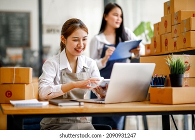 Two Asian young woman working together for SME project. Young Owner people startup for Business Online, SME, Delivery Project. Online Business and  Small business Concept