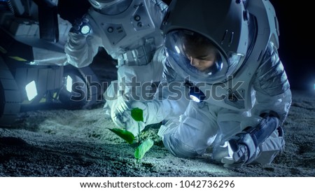 Two Astronauts on the Alien Planet Discover Plant Life. Space Travel, Discovery Of Habitable Worlds and Colonization Concept.