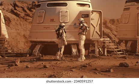 Two astronauts in spacesuits walk toward research station, colony or scientific base on Mars. Manned exploring space mission on red planet. Futuristic colonization and space exploration concept. - Shutterstock ID 2340591257