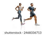 Two athletes sprinting, captured in moment of peak effort against white studio background. Synchronized movement. Concept of people in sport, healthy lifestyle, teamwork, motivation. Ad