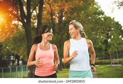 The Two athletic women in sportswear is jogging together - Powered by Shutterstock