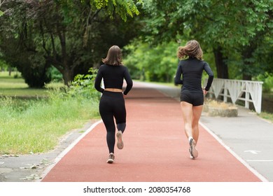 Two Attractive And Beautiful Young Girls Are Running In All Black Clothes