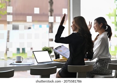 Two Attractive Business Woman Waving Hand And Saying Hello To Friend Or Acquaintance.