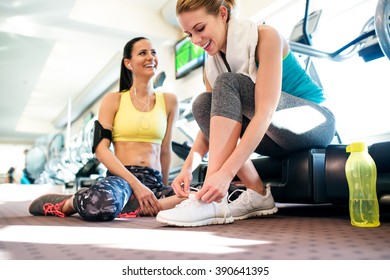 Two Attractive Fit Women In Gym Preparing For Workout