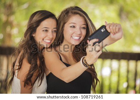 Similar – Two women laughing looking at their smart phone