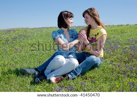 Similar – 2 young women sitting opposite each other