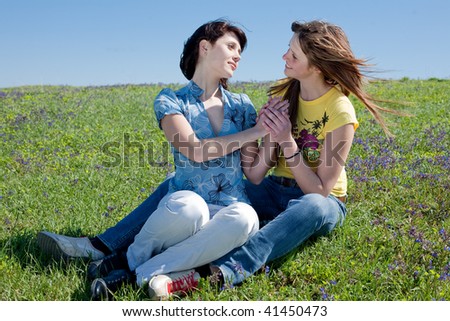 Similar – 2 young women sitting opposite each other