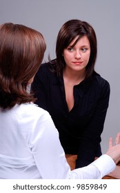 Two Attractive Young Woman Deep In Conversation