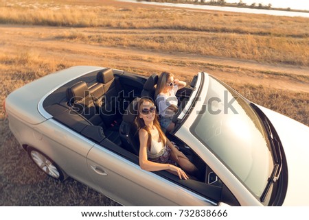 Image, Stock Photo Woman looking through the binoculars and friend driving