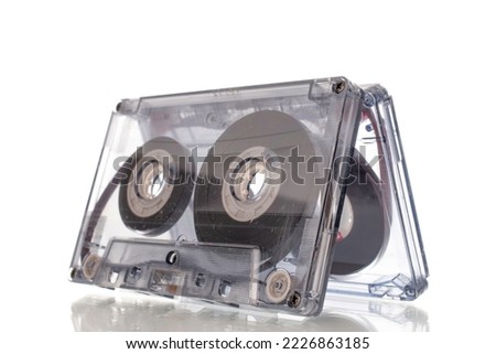 Two audio cassettes, macro, isolated on white background.