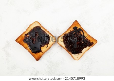 Two Aussie savory toasts for breakfast with thick Australian healthy food spread made from leftover brewers yeast extract.