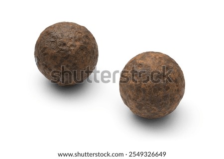 Two Authentic Rusty Civil War Cannonball Grape Shot Artifacts with Textured Surface isolated on White Background with Shadow