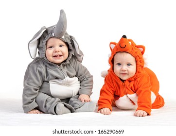 Two Baby Boys Dressed In Animal Costumes Over White