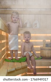 Two Baby In Sauna. Twin Boys Are Steaming In The Russian Bathhouse In Kilt