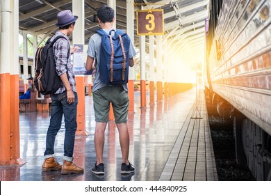 Two Backpackers Look At A Map At Train Station