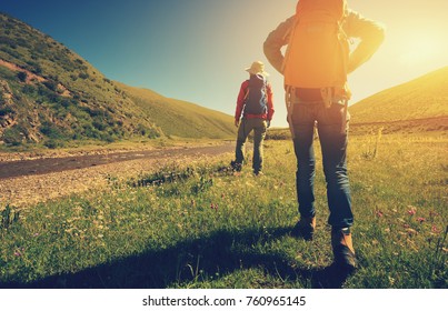 two backpacking women hiking in riverside mountains - Powered by Shutterstock