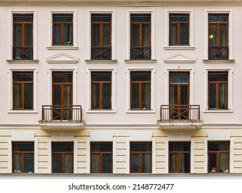 Two balconies and many windows in a row on the facade of the modern urban apartment building front view, Krasnaya Polyana, Sochi, Krasnodar Krai, Russia