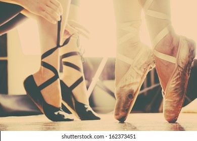 two ballerinas  in ballet shoes  put trough arty retro filter 