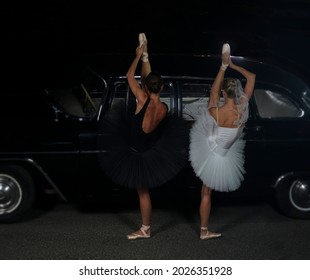 Two Ballet Dancer Dancing Near Black Vintage Car. Night Scene. 