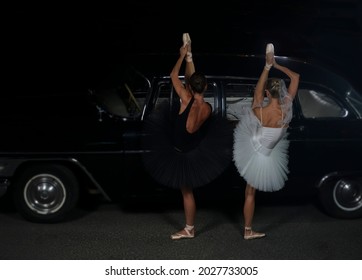 Two Ballet Dancer Dancing Near Black Vintage Car. Night Scene. 