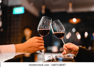 Two Bartender Enjoying Of Cheers Glass Of Wine For Wine Tasting Event In A Restaurant  At Sunset. Bartender, Tasting, Dinner, Wine, Beverage, Dinner Concept.