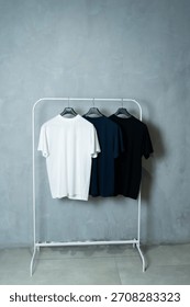 two basic colored T-shirts on a minimalist clothes rack
