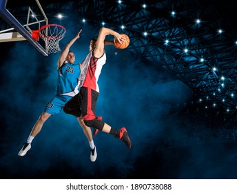 Two basketball players in action in arena. Blocked shot