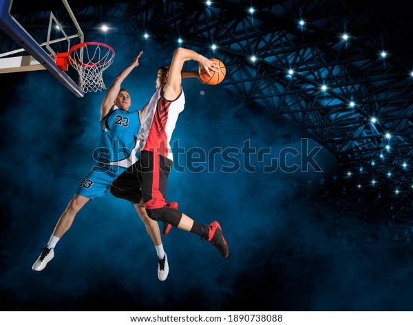 Two\
basketball players in action in arena. Blocked\
shot
