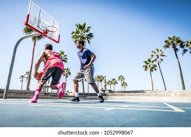 Two Basketball Players Playing Outdoor In LA