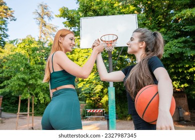 Two basketball players shake hands during a basketball game, fairness and respect - Powered by Shutterstock