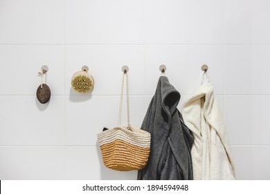 Two Bathrobes, A Basket And Sustainable Zero Waste Bathroom Accessories On A White Wall. Sustainable Home, Plastic Free Bathroom Concept.