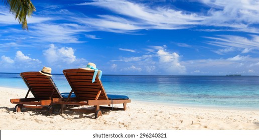 Two Beach Chairs On The Tropical Sand Beach