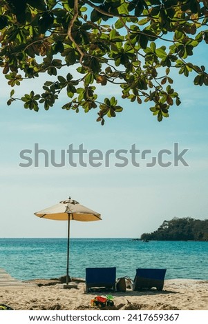 Two beach chairs side by side on sandy ocean front with view over blue sea, shallow depth of field. Romantic couple chairs. Tranquil togetherness love wellbeing, relax beautiful landscape.