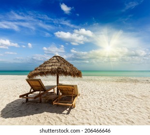 Two beach lounge chairs under tent on beach. Sihanoukville, Cambodia - Shutterstock ID 206466646