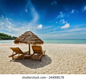 Two beach lounge chairs under tent on beach. Sihanoukville, Cambodia - Shutterstock ID 244008178
