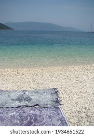 Two Beach Towels On White Pebble Beach, Antisamos, Kefalonia. Vertical