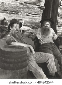 Two bearded men lounging
