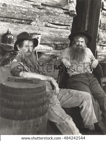 Two bearded men lounging
