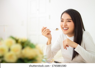 Two Beautiful Asian Women Are Sitting And Eating New Normal Lifestyle Couple Friend Use Plastic Spoon And Fork Eat Food