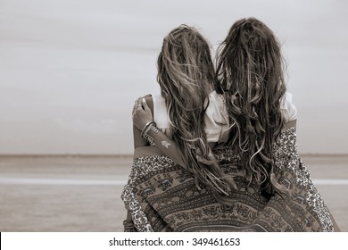 Two Beautiful Boho Girls Looking At Sea. Back View