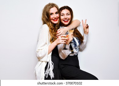 Two Beautiful Elegant Women Celebrate Hen-party And Drinking Champagne . Best Friends Wearing Black And White Stylish Evening Outfits .Bright Make Up, Red Lips. Indoors, B&w Crazy Party.