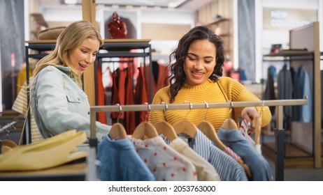 Two Beautiful Female Friends Shopping in Clothing Store, Choosing Stylish Clothes, Picking Dress, Blouse. Customers in Fashionable Shop, Colorful Brand, Sustainable Designs, New Seasonal Collection. - Powered by Shutterstock