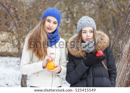 Two Beautiful girls on the nature in the winter outside in winter hat