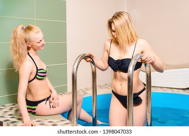 two beautiful girls in the pool. salon. slender blonde women in spa salon. Healthy lifestyle concept. body care